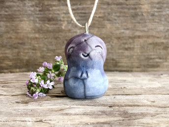 raku ceramic smiley Jizo pendant, glazed in a bottom-to-top gradient of blue and violet, strung on adjustable eco flax cord.