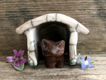 Small brown raku ceramic Shinto Inari kitsune fox kami sculpture with his very own little ceramic house. The house is glazed to look like it has a terracotta tiled roof and cherry blossom drifting across its white walls. A perfect mini shrine. 