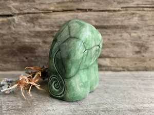 Raku ceramic sculpture of an elemental earth spirit gnome. He is very gentle and glazed in green with Celtic spiral decorations.