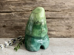 Raku ceramic earth and plant spirit sculpture glazed in forest green to a bright spring green (bottom to top). It has a gentle, smiling face.
