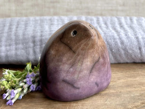 a lovely-to-hold little sculpture of a stylised mole friend. a bit like a large raindrop with a pointy nose? it's glazed in a bottom-t-o-top gradient of purple to warm brown and has a kind, gentle face.