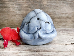 A smiley, loving, and very happy Jizo Shinto raku ceramic sculpture glazed in soft blue with sweet little praying hands.