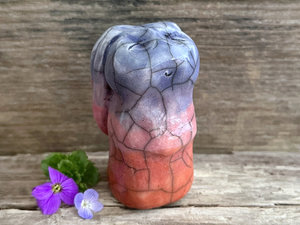 Raku ceramic usagi rabbit kami nature spirit glazed in a bottom-to-top gradient of burnt orange to mauve to indigo-violet. Its ears are folded down its back, and it has a kind, gentle face.