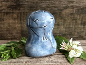 A smiley, loving, and very happy Jizo Shinto raku ceramic sculpture talisman in blue with a heart shape around her face. A wonderful smooth shape to hold in the hand.