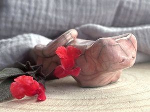 Little raku ceramic cat spirit kami sculpture glazed in a soft red-pink colour and with a kind, gentle face.