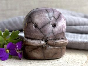 A kodama nature spirit ceramic guardian statue glazed in a bottom-to-top gradient of warm brown to soft mauve. It has a wide face, two big eyes, and cute little arms.