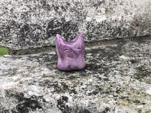 Ceramic raku earth elemental kami nature spirit sculpture glazed in mauve. She has pointed ears and a kind face, lovely for a Shinto shrine, shamanism, or rewilding.
