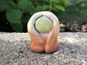 Ceramic raku autumn and fall goddess sculpture in pale red, orange, yellow, and green. She has a gentle, smiling face and would be lovely for a Shinto kamidana shrine, pagan altar, shamanism, Waldorf nature table, or rewilding.
