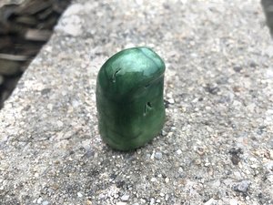 A sweet, tiny kodama nature and forest spirit kami ceramic raku sculpture glazed in greens with a happy, gentle smiling face. Lovely for a Shinto kamidana shrine, pagan altar, shamanism.