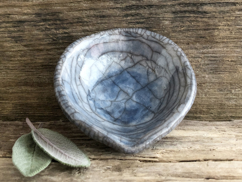 Raku ceramic offering bowl with a small spout. The bowl is glazed in blue and grey with a beautiful raku crackle pattern.