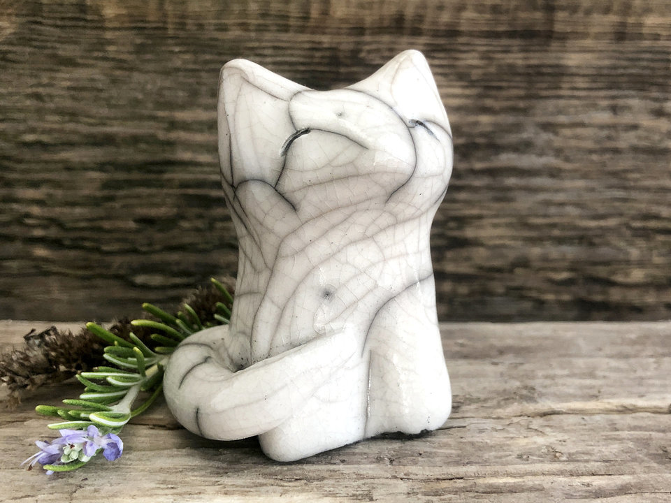 Sitting white wolf raku guardian spirit guide sculpture with a kind and gentle face.