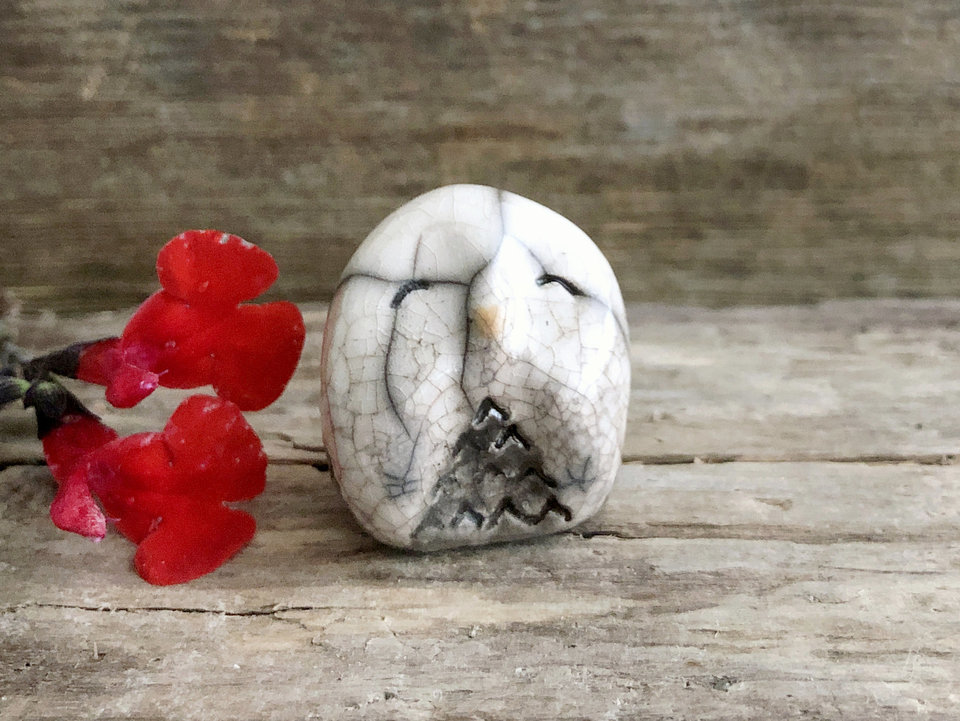Raku ceramic little owl or owlet kami nature spirit statue glazed in white and grey-brown with impressive raku crackling, happy eyes, and a little orange beak.