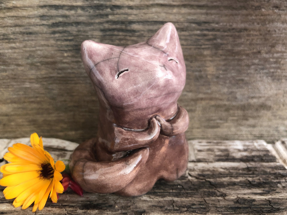 Raku ceramic kitsune fox sculpture. He has sweet praying hands and a gentle, upturned face. He is glazed in warm brown and soft mauve pink.