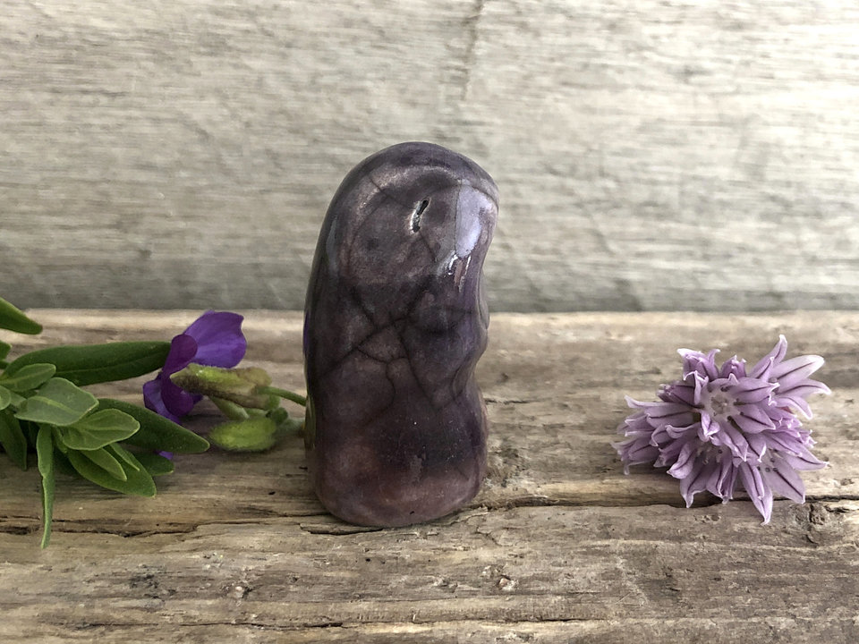 Raku ceramic guardian of the evening wood elemental kami nature spirit statue, glazed in dark muted purple and mauve.