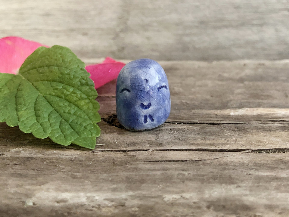 Pocket-sized tiny, smiley Jizo ceramic raku Shinto statue sculpture glazed in blue.
