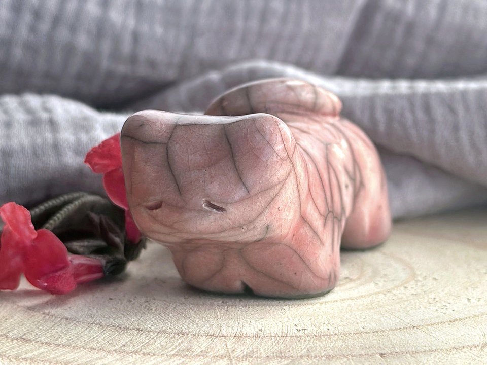 Little raku ceramic cat spirit kami sculpture glazed in a soft red-pink colour and with a kind, gentle face.