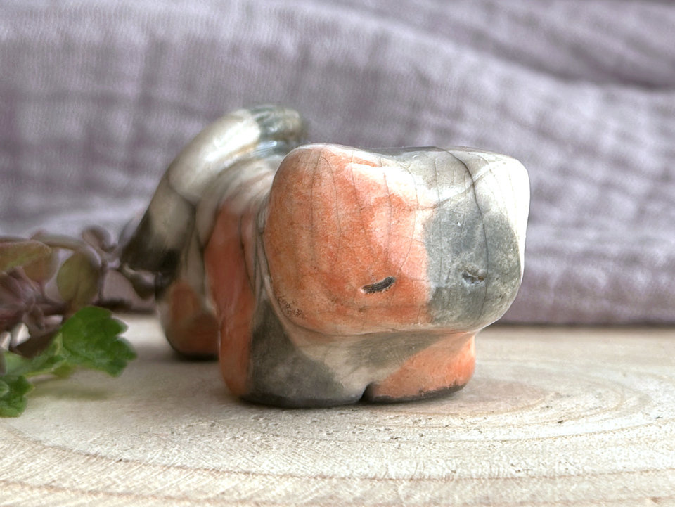 Little raku ceramic cat spirit kami sculpture glazed in a calico pattern (warm red-orange, grey, and white) and with a kind, gentle face.