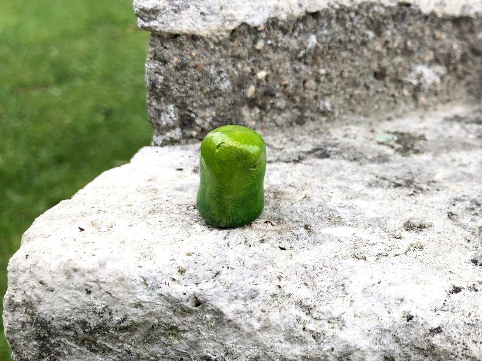 A sweet, tiny kodama nature and forest spirit kami clay sculpture painted in spring green with a dusting of gold. He has a happy, gentle smiling face and would be lovely for a Shinto kamidana shrine, pagan altar, shamanism.