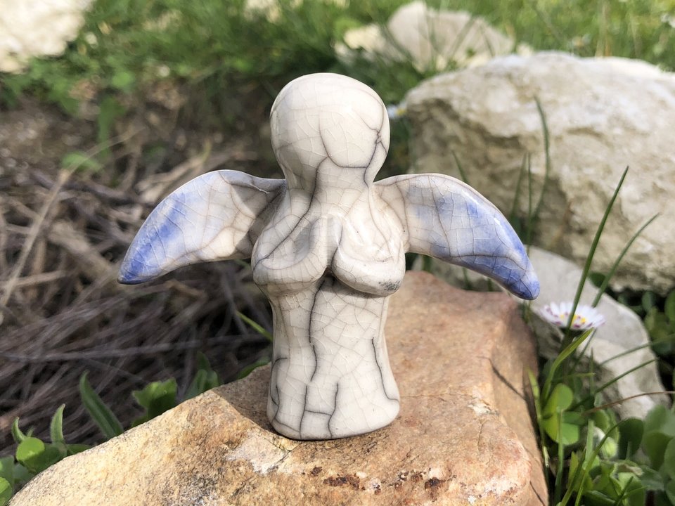 White raku ceramic angel sculpture with praying hands and blue-tipped wings. Lovely statue for peace, contemplation, compassion.