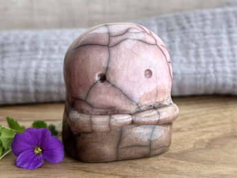 A kodama nature spirit ceramic guardian statue glazed in a bottom-to-top gradient of warm brown to soft pink-mauve. It has a wide face, two big eyes, and cute little arms.
