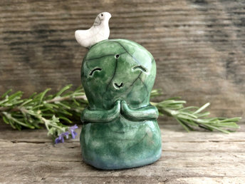 Shinto Jizo nature spirit guardian ceramic statue glazed in blue and green with a happy, smiley face, little praying hands, and a sweet white bird on his head.