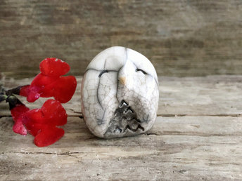 Raku ceramic little owl or owlet kami nature spirit statue glazed in white and grey-brown with impressive raku crackling, happy eyes, and a little orange beak.