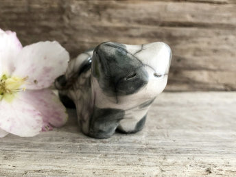 Little raku ceramic cat spirit kami sculpture glazed in dark grey and white. It has a kind, gentle, slightly sleepy face.
