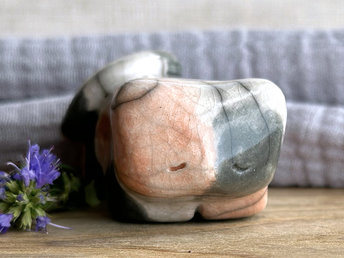 Little raku ceramic cat spirit kami sculpture glazed in a calico pattern (soft red-orange, grey, and white) and with a kind, gentle face.