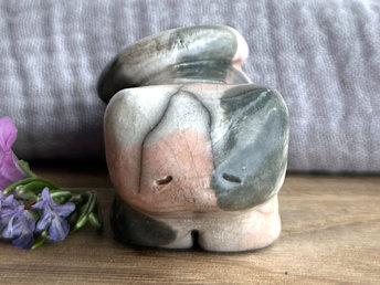 Little raku ceramic cat spirit kami sculpture glazed in a calico pattern (soft orange, grey, and white) and with a kind, gentle, and sleepy face.