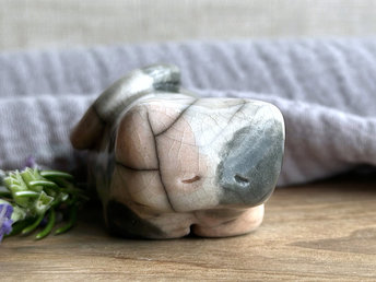 Little raku ceramic cat spirit kami sculpture glazed in a calico pattern (soft, pale orange, grey, and white) and with a kind, gentle, and sleepy face.