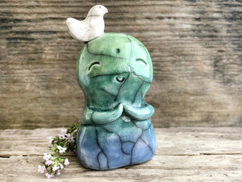 Shinto Jizo nature spirit guardian ceramic statue glazed in a bottom-to-top gradient of blue and green with a happy, smiley face, little praying hands, and a sweet white bird on his head.