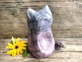 Raku ceramic sitting fox glazed in a bottom-to-top gradient from mauve-purple to indigo. It has a kind face, and its front is curved in with a place for your thumb.
