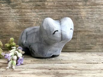 Ceramic raku bear kami sculpture glazed in pale grey-blue. It has a kind, gentle face.