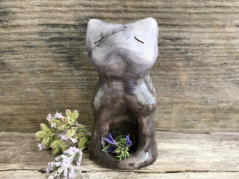 Raku ceramic sitting fox glazed in a gradient from brown to pale indigo-blue (bottom to top). It has a kind, quiet face, and its front is curved in with a little hollow for sacred objects.