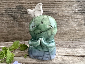 Shinto Jizo nature spirit guardian ceramic statue glazed in a bottom-to-top gradient of blue and green with a happy, smiley face, little praying hands, and a sweet white bird on his head.
