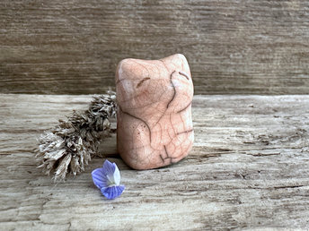 very small raku ceramic fox sculpture glazed in a peach colour. it has a gentle face.