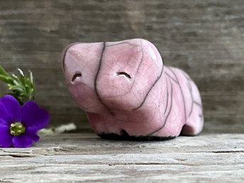 Ceramic raku bear kami sculpture glazed in soft pinky red. It has a kind, gentle face.