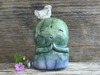 Shinto Jizo nature spirit guardian ceramic statue glazed in a bottom-to-top gradient of blue and green with a happy, smiley face, little praying hands, and a sweet white bird on their head.