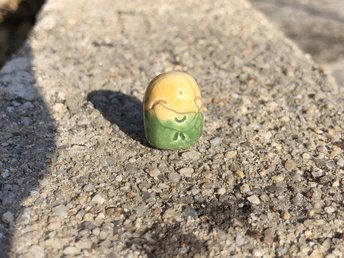 Pocket-sized tiny Jizo ceramic raku Shinto statue sculpture glazed in yellow and green..