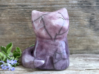 A calm and gentle Shinto Inari nighttime moon kitsune fox kami spirit ceramic raku statue glazed in a bottom-to-top gradient of purple to soft mauve. Its tail is curled around its body on its right side.