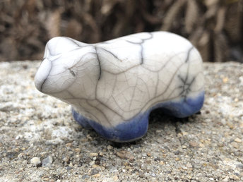 Ceramic raku white polar bear kami sculpture glazed in white with blue and turquoise around his feet. He has a kind, gentle face and would be lovely guardian spirit for shamanism or a Shinto kamidana shrine.