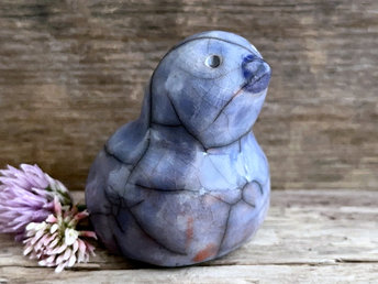 Raku ceramic bird kami nature spirit glazed in blue with hints of burnt orange. It has a dark blue beak and a very sweet, gentle face.