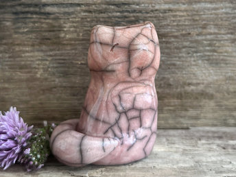 raku ceramic sitting fox glazed in a gradient from soft pink to orange (bottom to top) with beautiful raku crackles. it has a kind face, and its tail is curled around it on its right side.