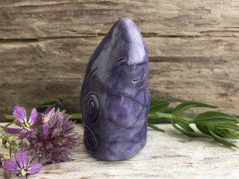 Raku ceramic sculpture of an elemental earth spirit gnome. He is very friendly and glazed in violet with Celtic spiral decorations.