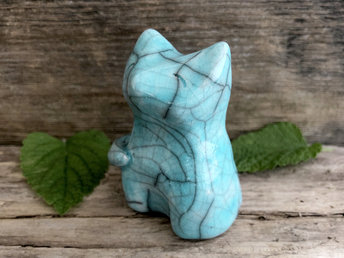 Raku ceramic sitting kitsune fox glazed in a soft tuquoise colour. He looks very happy and tranquil, and his head is uplifted gently toward the sky.
