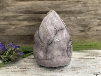 Raku ceramic sculpture of an elemental earth spirit gnome. He is very friendly and glazed in pale grey-violet with Celtic spiral decorations.