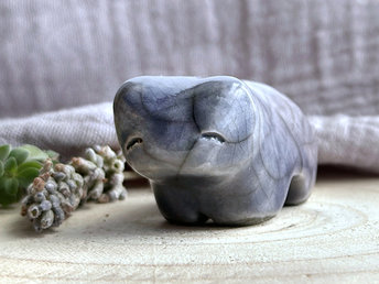 Ceramic raku bear kami sculpture glazed in a nose-to-tail gradient of grey-blue to soft grey-violet. It has a kind, gentle face.