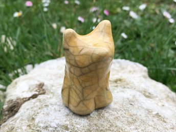 Sweet raku ceramic bear cub kami sculpture glazed in warm yellow and sitting up. Friendly and gentle nature spirit animal totem guide statue for Shinto or shamanism. 
