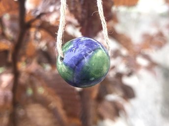 Beautiful raku ceramic spherical bead glazed in blue and green like the earth and strung on an adjustable eco-hemp cord. Lovely pendant necklace for earth healing or rewilding.