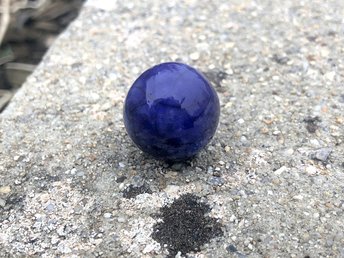 Raku ceramic marble (with a flat bottom) glazed in deep blue and indigo. Lovely to play with and hold in your hand, it would make a wonderful, calming focus for meditation.